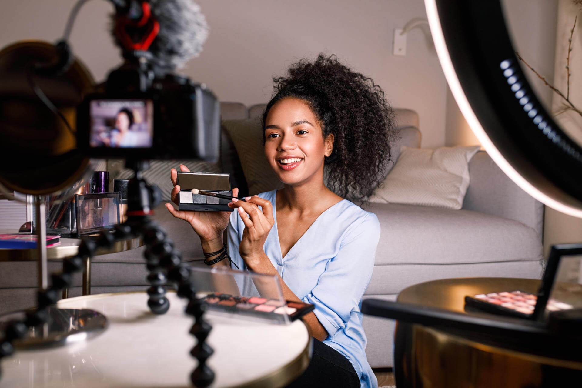 smiling-woman-holding-a-makeup-palette-while-recor-2025-03-06-14-38-39-utc.jpg